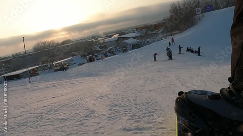 A snowboard-mounted camera captures the action of the boot, snowboard, and mountain slope. Shooting on the move GoPro 4K