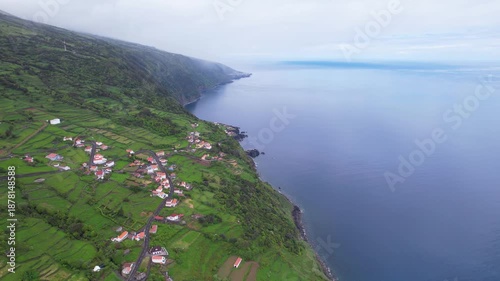 AZORES - 11.3.2025 - Beautiful aerial footage drawing back from a remote coastal community on the Azores' Sao Jorge Island.