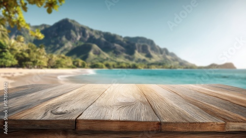 Empty wooden deck overlooking scenic tropical beach and lush green mountains.