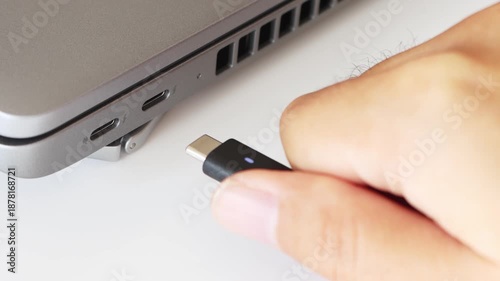 ノートパソコンからUSBケーブルを抜くメージ（USB-C）