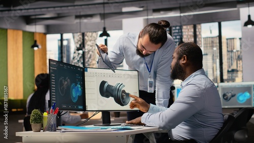 Fotografía Team of technicians working together to upgrade turbine parts to maximize sustainability
