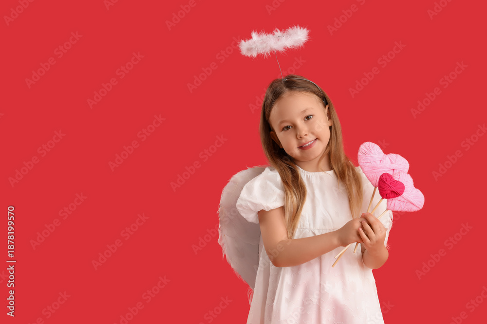 Fototapeta premium Cute little girl dressed as cupid with hearts on red background. Valentine's Day celebration