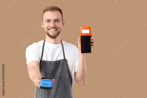 Male barista with payment t...