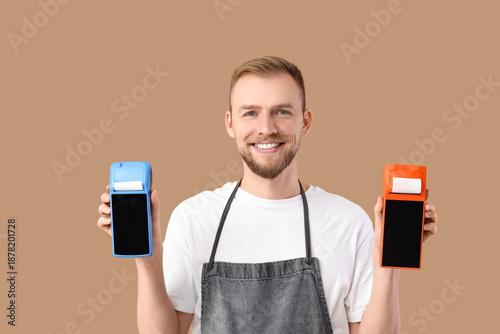 Male barista with payment t...