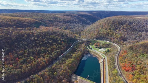 PENNSYLVANIA - 11.10.2025 - Stunning aerial footage of a freight train traveling on Pennsylvania's Horseshoe Curve, surrounded by autumn trees.