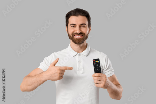 Young man pointing at TV re...