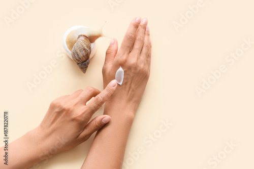Wallpaper Mural Female hands with snail and jar of cream on beige background Torontodigital.ca
