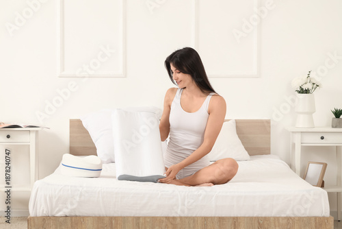 Young woman in pajamas hold...