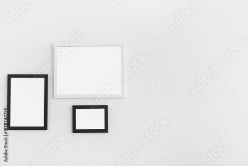 Photo frames on light wall