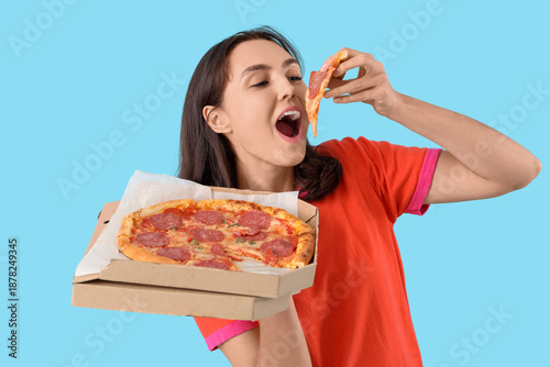 Young woman eating tasty pe...