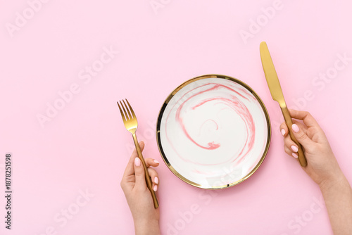 Woman with cutlery and empt...