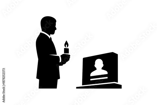 Silhouette of a man holding a burning candle next to a tombstone for mourning and remembrance