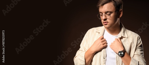 Stylish young man on dark b...