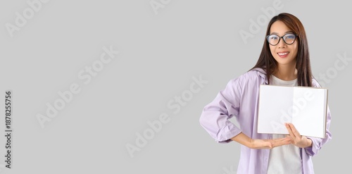 Young Asian woman with blan...