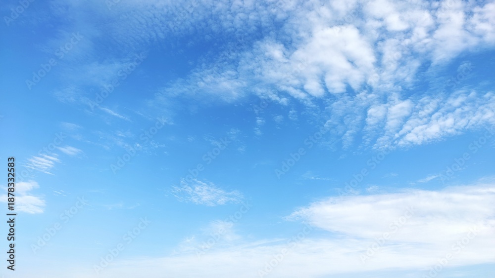Fototapeta premium Beautiful bright blue sky with white wispy cirrus clouds background.