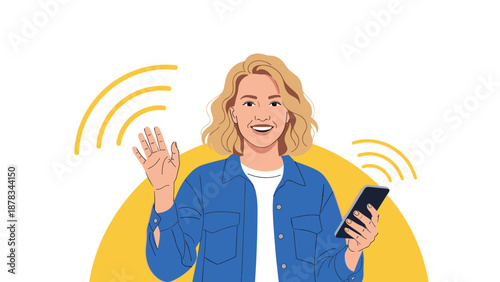 Friendly blonde woman in a blue denim jacket waves hello while holding her smartphone, ready for a video call or social post.