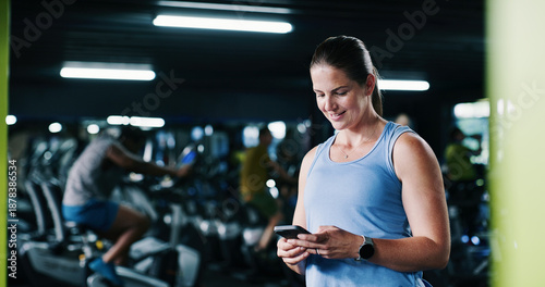 Photos Fitness, woman and happy with phone at gym for health progress, membership renewal and sign up