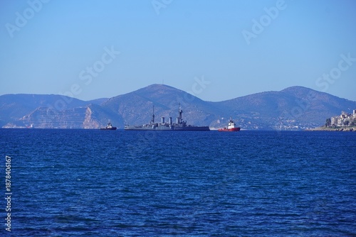 Bild auf Leinwand The old, historic, battle cruiser Averof under tow near the coast of Piraeus, Gr