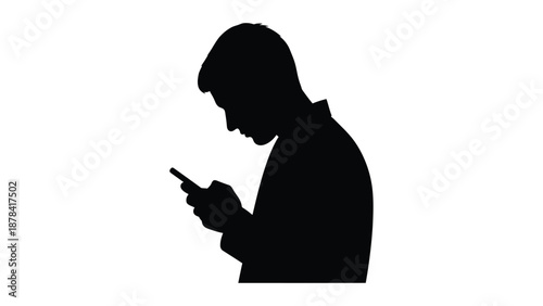 Silhouette profile of a young man intently focused while using a small handheld mobile communication device against a white background