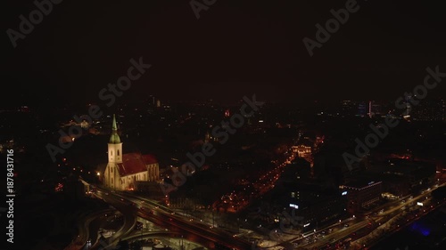 Wallpaper Mural Aerial night view of Bratislava Old Town with St. Martin’s Cathedral illuminated above busy streets. Winter city atmosphere, historic landmark, calm evening scene. Torontodigital.ca