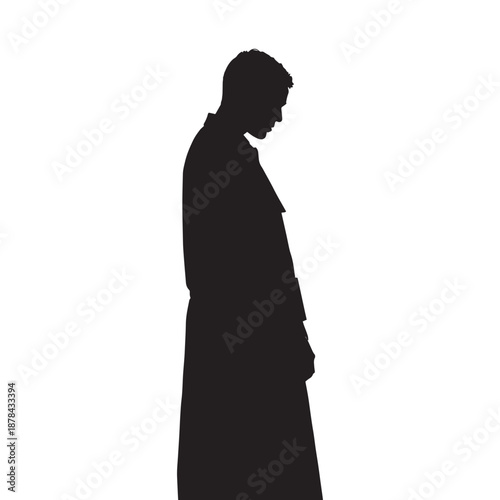 Silhouette of a man in a long coat standing alone