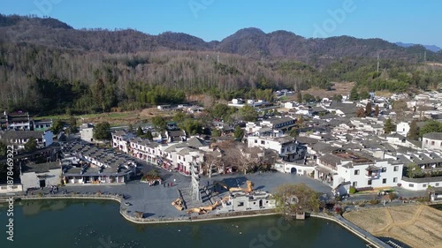 Xidi, China: Aerial drone footage of the famous Xidi ancient village with its famous paifang, a memorial archway, in the countryside near Huangshan in Anhui province in China. 