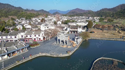 Xidi, China: Aerial drone footage of the famous Xidi ancient village with an orbit motion around its famous paifang, a memorial archway, near Huangshan in Anhui province in China. 
