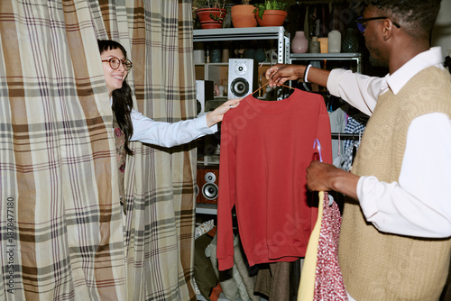 Cuadro en lienzo Biracial young woman emerging from fitting room smiling while Black young adult
