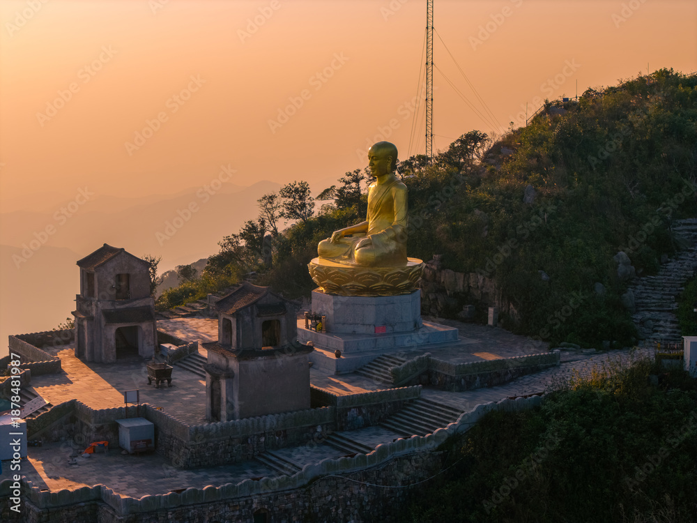 custom made wallpaper toronto digitalView of Golden statue of Buddha sitting in a lotus flower at ancient Buddhist complex at Yen Tu Mountain, Quang Ninh Province, Vietnam