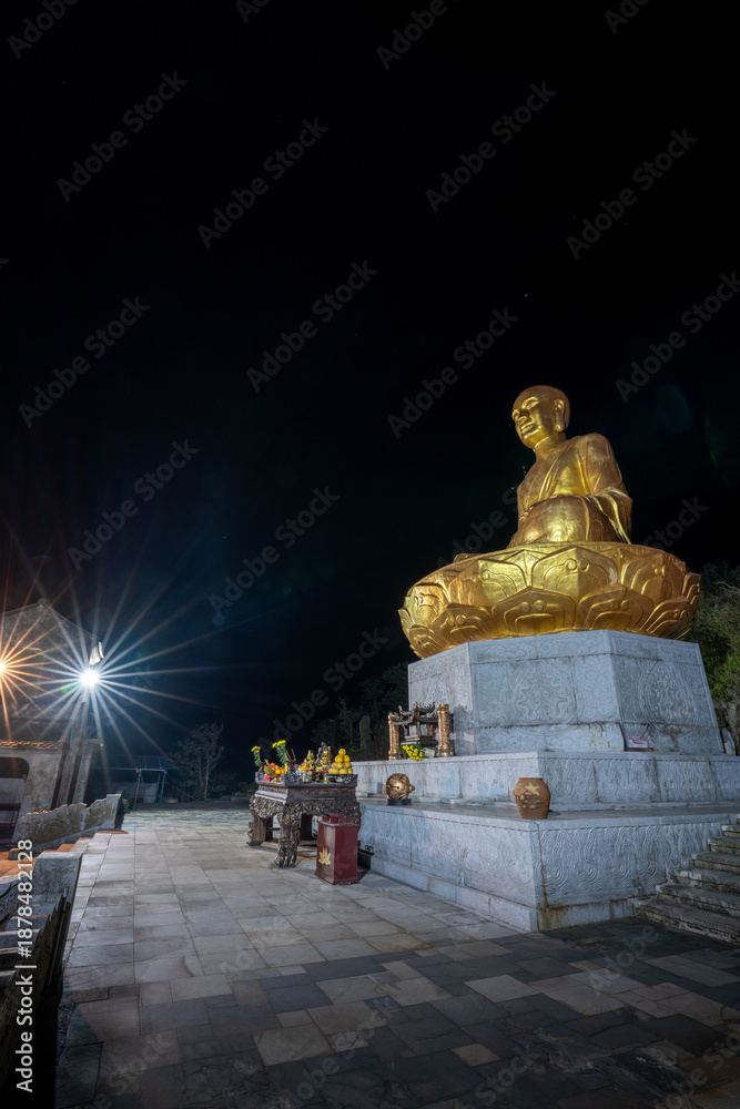custom made wallpaper toronto digitalView of Golden statue of Buddha sitting in a lotus flower at ancient Buddhist complex at Yen Tu Mountain, Quang Ninh Province, Vietnam