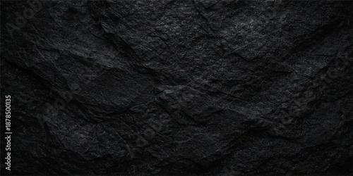 Dark black leather and fabric material texture with a rough macro surface pattern creates a natural textile backdrop for fashion design