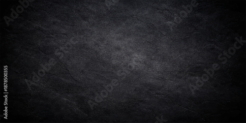 A dark and black grunge background with copy space featuring a textured gray concrete wall surface and a rough vintage paper pattern for an empty old backdrop design