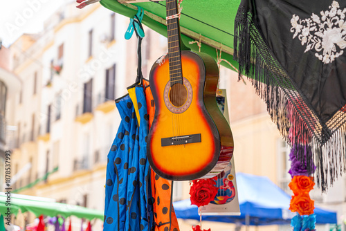 Colorful market scene with guitar and textiles.. Málaga, Spain