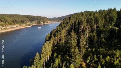 Aerial drone footage of flight over trees at the shore of the Schluchsee in the Black Forest in Southern Germany