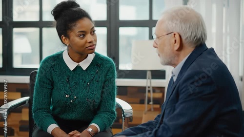 Senior therapist consulting with young woman patient during counseling session, demonstrating mental health support and personal wellbeing.