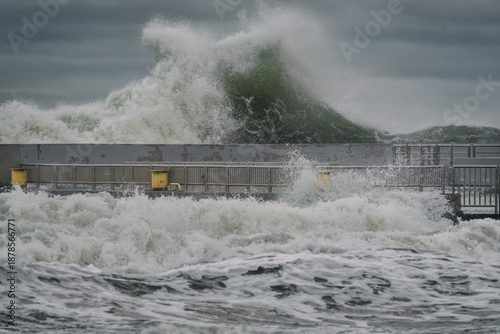 STORM AT SEA - Powerful waves of foaming sea water at the pier