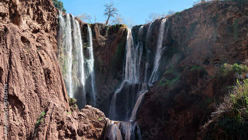 Majestic Ouzoud waterfalls cascade through cliffs in Morocco on a sunny day
