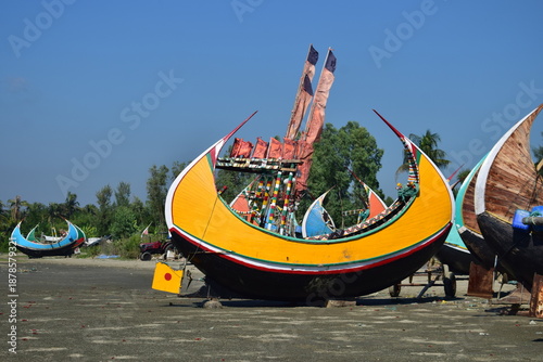 Sampan Boat on the Beach - Coastal Simplicity and Tradition. A traditional sampan boat rests quietly on the beach, reflecting the timeless bond between coastal life and the sea.