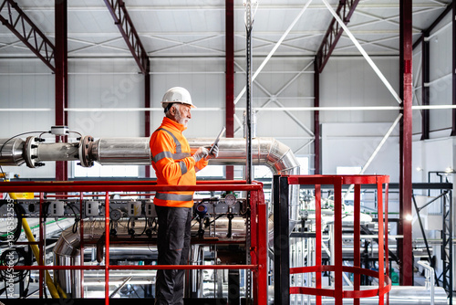 Obraz na plátně Experienced engineer working with tablet in industrial plant
