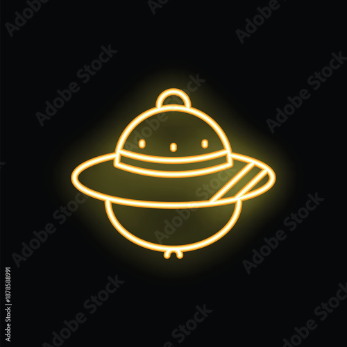 Yellow neon sign of a classic ufo design glowing on a black background