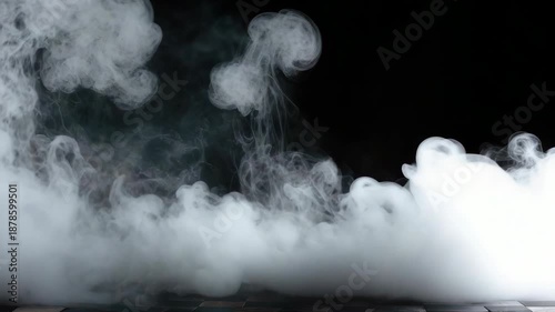 A clear glass beaker with boiling liquid and steam being released into the air