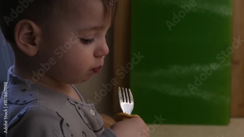 Toddler Eating with Fork in Pajamas
