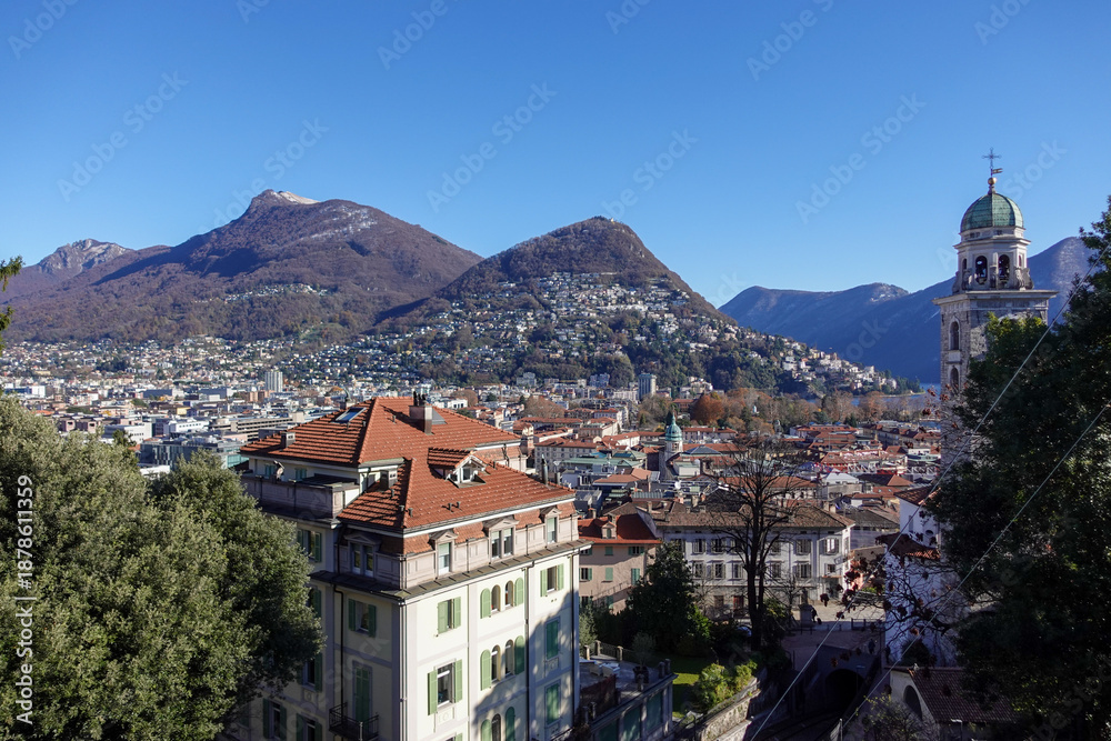 Fototapeta premium A sweeping view of Lugano, Switzerland, where the city, lake, and surrounding mountains come together in perfect harmony.