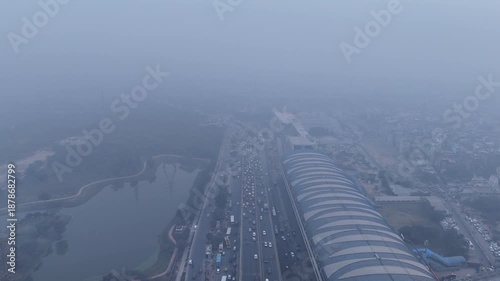 Aerial view of Sarai Kale Khan, Delhi, showing traffic and urban infrastructure under dense smog and poor air quality
