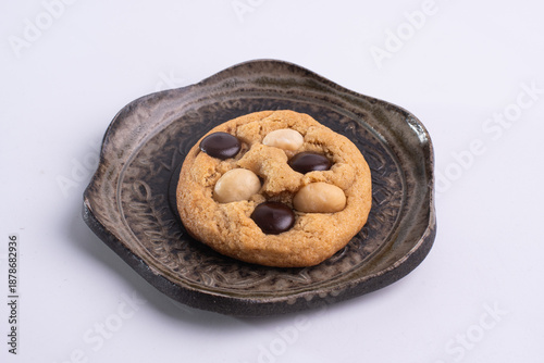 soft cookies with almond macadamia and chocolate on a table and plate