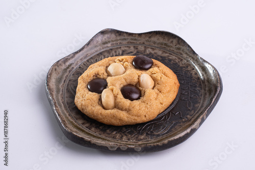 soft cookies with almond macadamia and chocolate on a table and plate