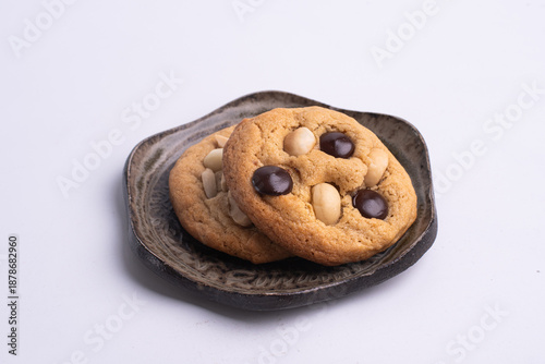 soft cookies with almond macadamia and chocolate on a table and plate