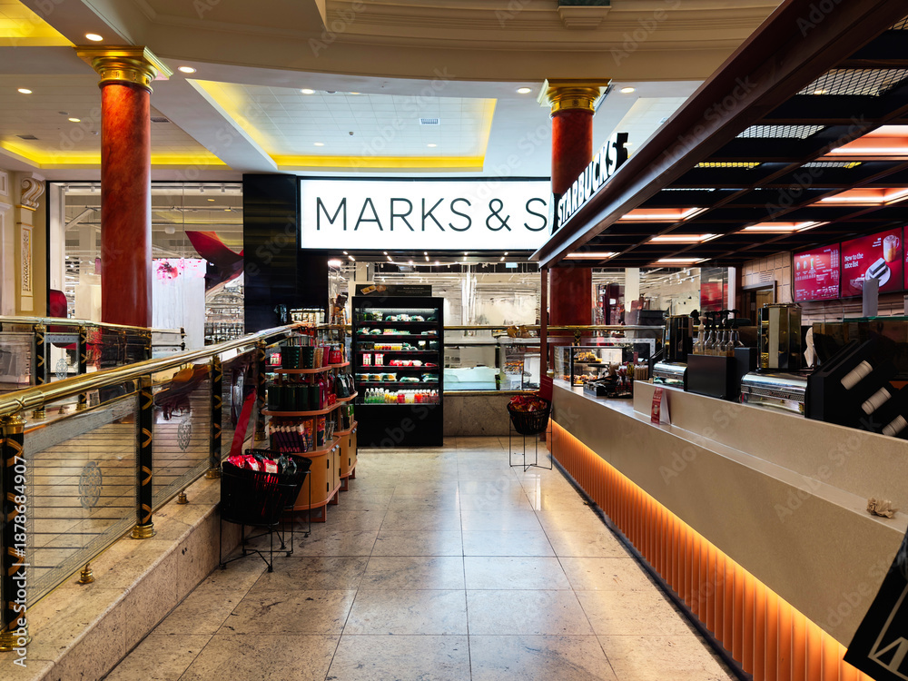 Fototapeta premium Shoppers in a Manchester mall browse stores and grab drinks near MarksandSpencer and Starbucks