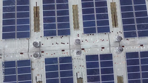 Drone Rotating Around Center Above Solar Panel Rooftop Creating Symmetrical Geometric Pattern