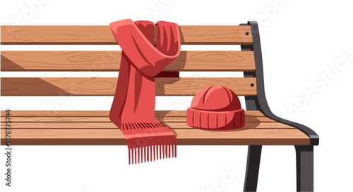 Red scarf and hat on wooden park bench in winter scene  